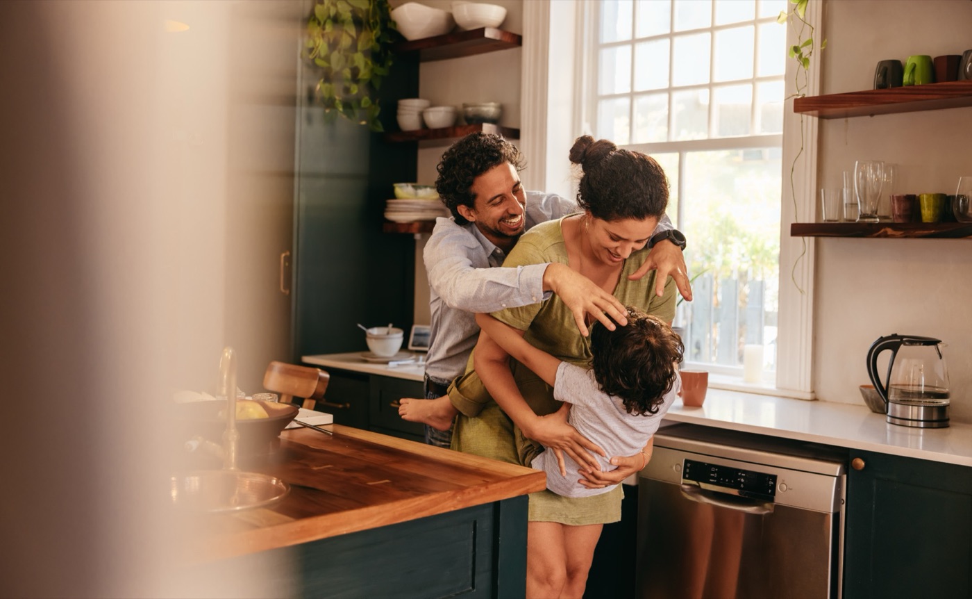 A happy family together in their freshly cleaned kitchen