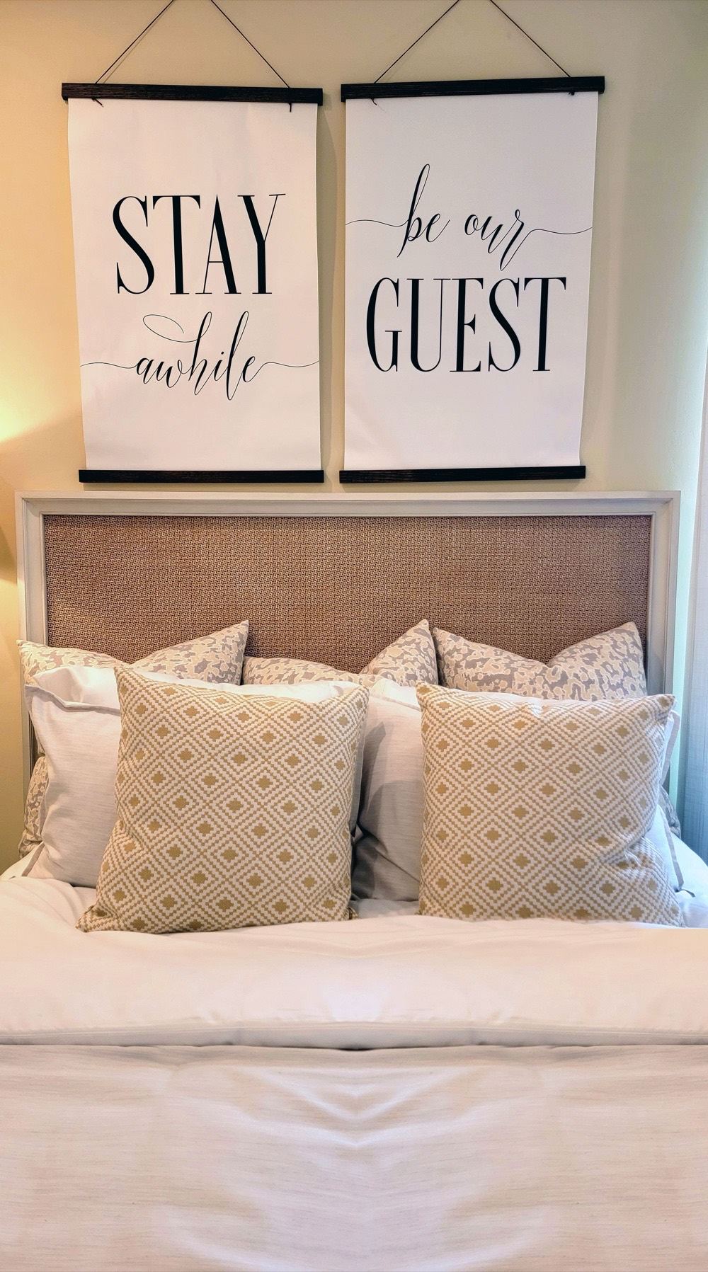Styled guest bed with decorative pillows, staged for the next Airbnb guest