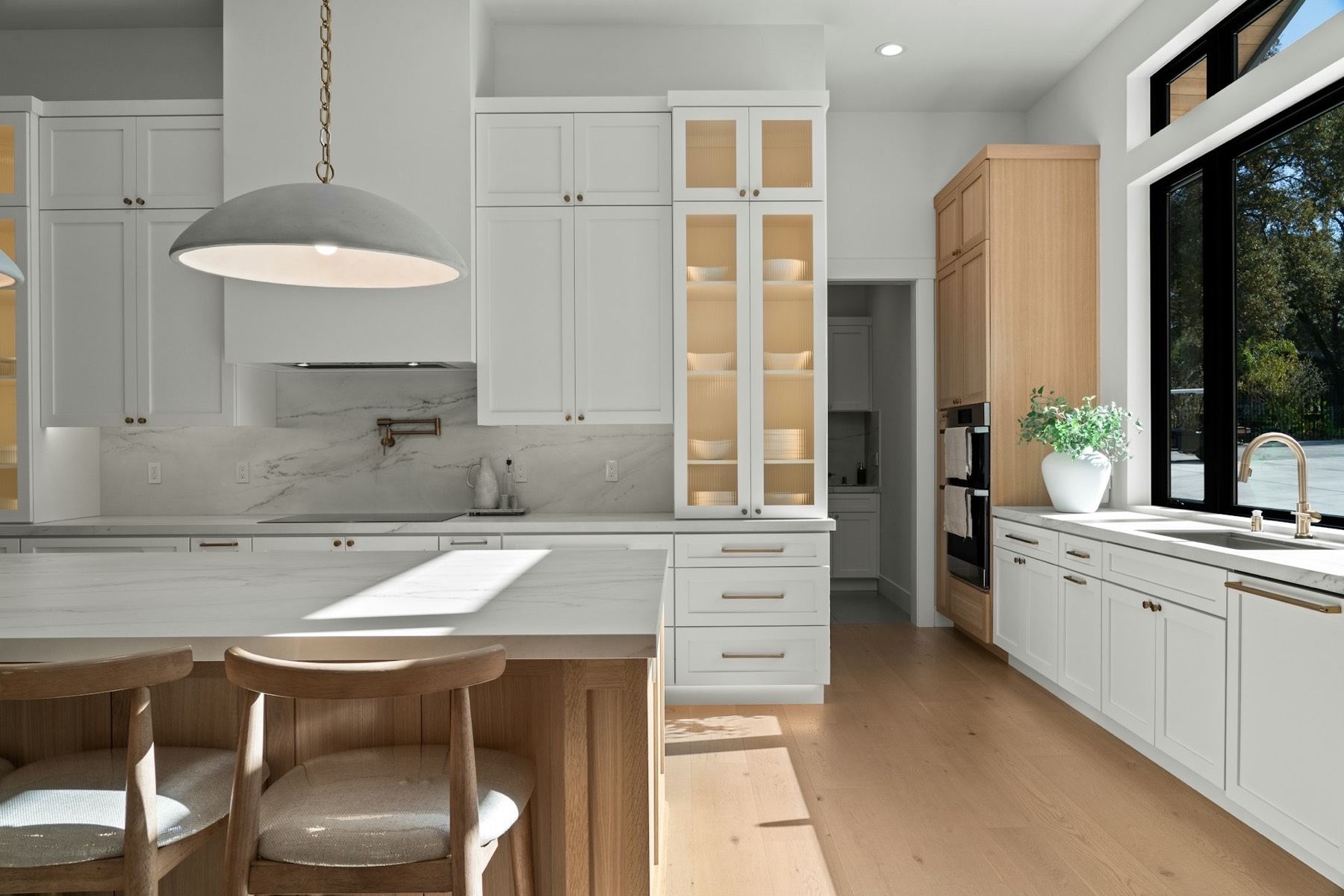 Spotless white kitchen with marble backsplash after a one-time standard clean